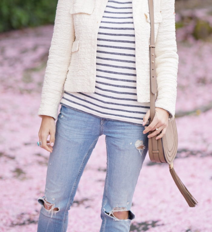 Christine Cameron wearing a vince camuto saddle bag next to cherry blossoms on queen anne hill in seattle 4