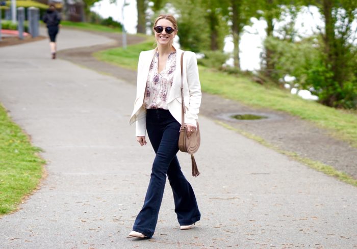 Christine Cameron wearing a white blazer with dark wide leg denim by Hudson and Vince Camuto purse 1