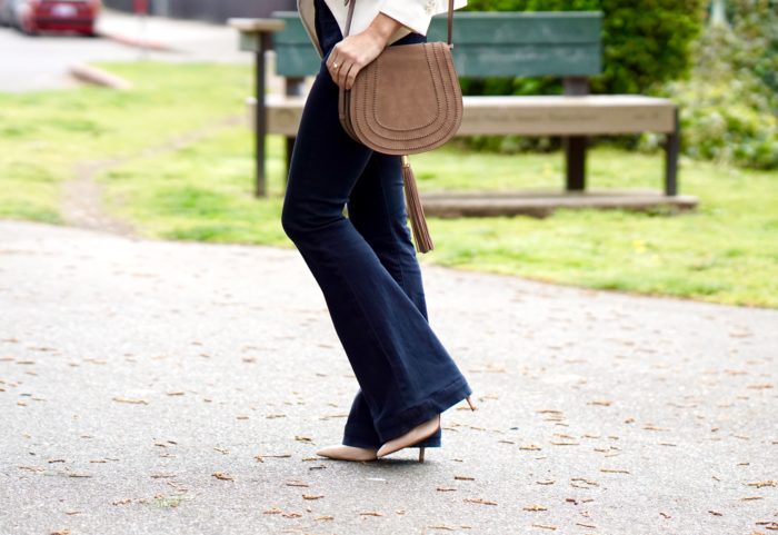 Christine Cameron wearing a white blazer with dark wide leg denim by Hudson and Vince Camuto purse 3