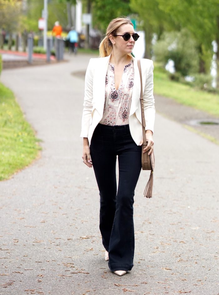 Christine Cameron wearing a white blazer with dark wide leg denim by Hudson and Vince Camuto purse 4